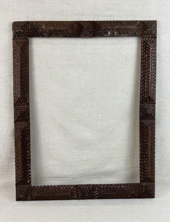 Tramp Art Criss Cross Frame: Tramp Art frame featuring a richly textured surface with layered chip-carved wood arranged in geometric patterns and traditional stepped construction. The notched detailing and hand-carved elements