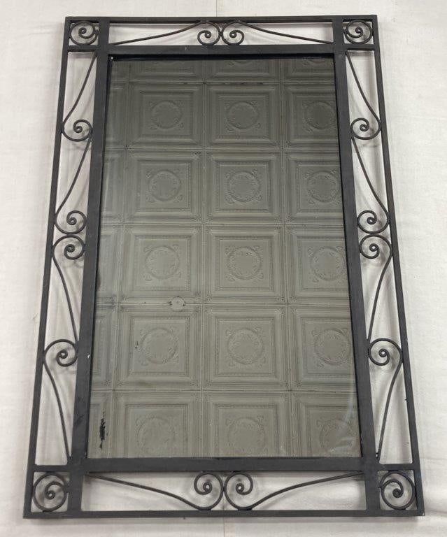 Wrought Iron Scrollwork Mirror: An elegant wall mirror featuring an openwork frame of decorative wrought iron. The design is characterized by fluid, symmetrical scrollwork that creates a delicate yet substantial silhouette around