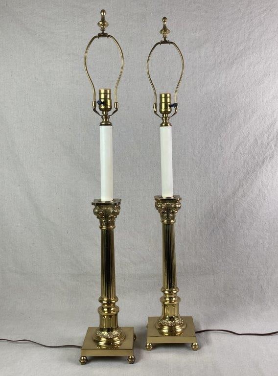 Pair of Neoclassical Style Brass Lamps: Luminous brass lamps with columnar Corinthian-style forms, featuring fluted shafts and decorated capitals. One measures approximately 35 3/4" H x 5 1/2" W x 5 1/2" D. Tested for functionality. Good