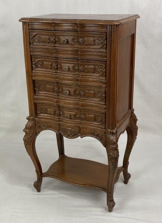 Carved French Chest: A finely crafted small chest featuring a serpentine front with four drawers, each retaining a rich, aged patina. The piece is raised on elegant cabriole legs, notably embellished with characterful