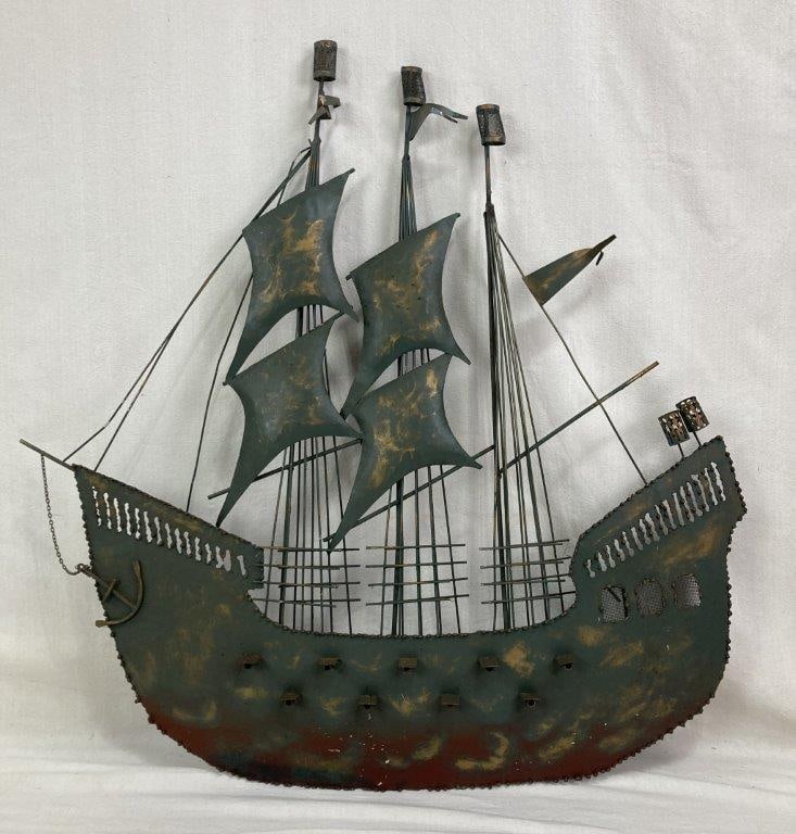 Mid Century Modern Ship Sculpture: Mid Century Modern metal sculpture depicting a stylized ship form constructed from layered and cut metal elements. The piece features a green polychromed finish, creating strong geometric lines and a