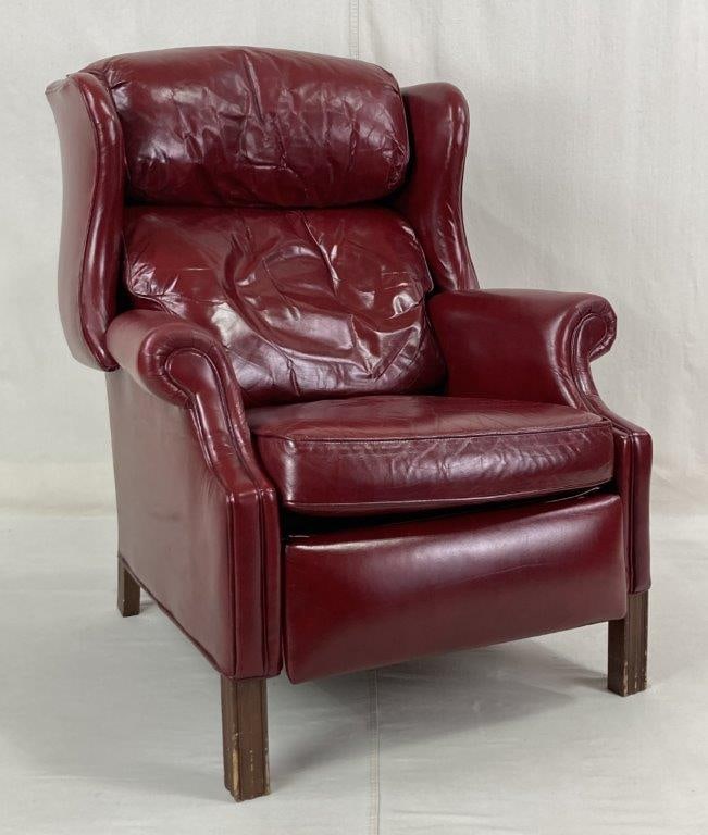 Oxblood Leather Wingback Chair Recliner: An elegant wingback reclining armchair upholstered in rich red oxblood leather by Bradington Young. The chair features a classic wingback silhouette and is supported by compact, straight reeded legs.