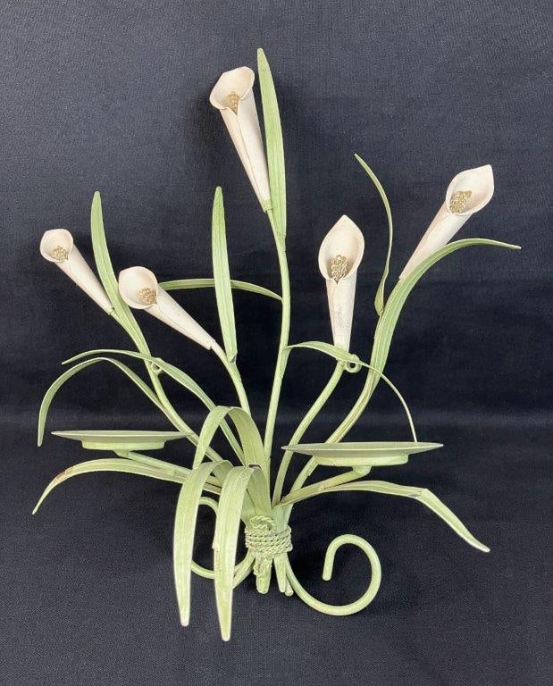 Tole Calla Lily Sconce: Elegant tole wall sconce featuring calla lily forms with leaves, all composed of twisting metal. Designed with two spaces for candle placement. Measures approximately 16" H x 13" W x 5 1/2" D. Some