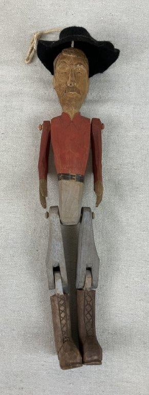 Folk Art Carved Dancing Prospector Doll: Folk art carved wooden dancing doll depicting a prospector figure with articulated limbs and expressive hand-carved facial features. The figure is finished with painted details and fitted with a felt