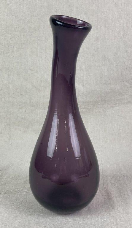 Amethyst Art Glass Bud Vase: A hand-blown glass bud vase of elegant swan-neck form, with a bulbous base rising to a slender curved neck, executed in deep amethyst glass. Measures approximately 12'' H x 4 1/4'' W x 4 1/2'' D,