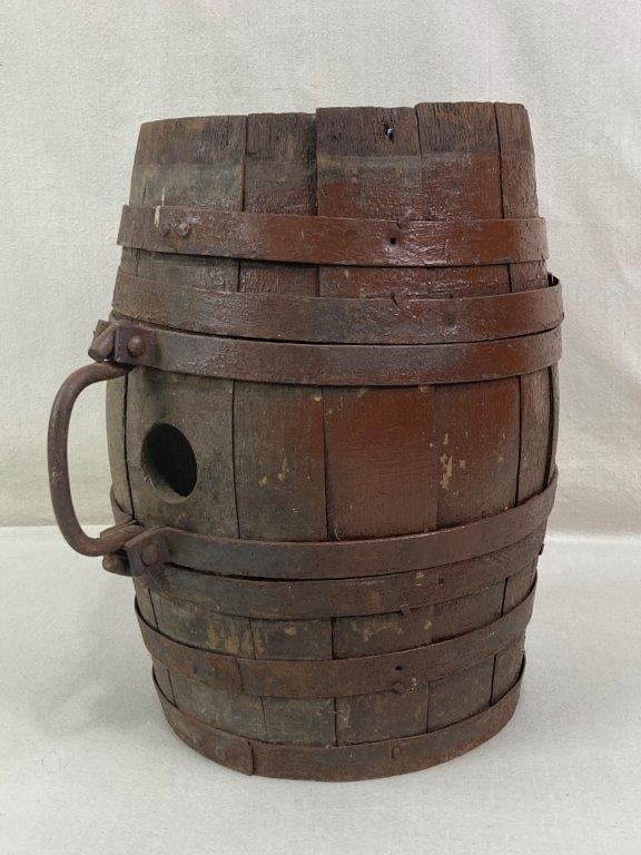 Rustic Iron Banded Cask: Rustic cask featuring a rounded robust form with iron banding and a forged metal handle. The piece displays utilitarian craftsmanship with aged wood and metal elements characteristic of traditional st