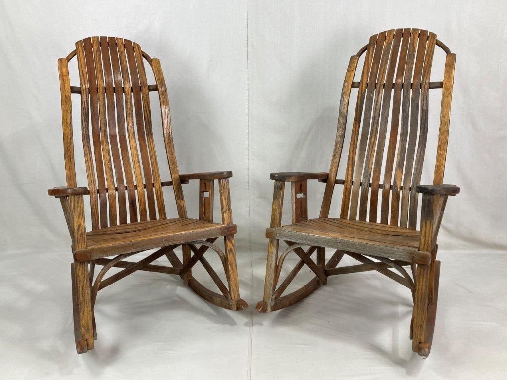 Pair of Amish Bentwood Slat Rocking Chairs: A pair of handcrafted rockers featuring contoured high curved backs with a rustic-inspired aesthetic. The chairs showcase fine artistry with cross-design armrest supports and structural criss-cross