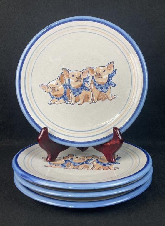 Louisville Stoneware Precious Pig Plates: Set of four dinner plates featuring a hand-painted design of three pigs wearing blue polka-dot bandanas. Each plate has a bold, hand-brushed cobalt blue rim framed by two thinner concentric rings in