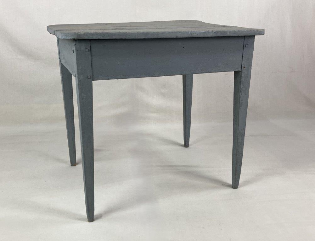Grey Country Table: Country table with a two-board top, pinned construction, and tapered legs, displaying a worn aged patina. Measures approximately 25â€³ H x 28â€³ W x