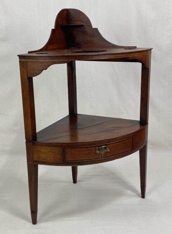 Mahogany American Washstand: Attributed to Natural Bridge, Virginia, featuring a triangular top tier surmounted by a shaped gallery splashback and pierced for a basin and wash articles. The stand is raised on three square,