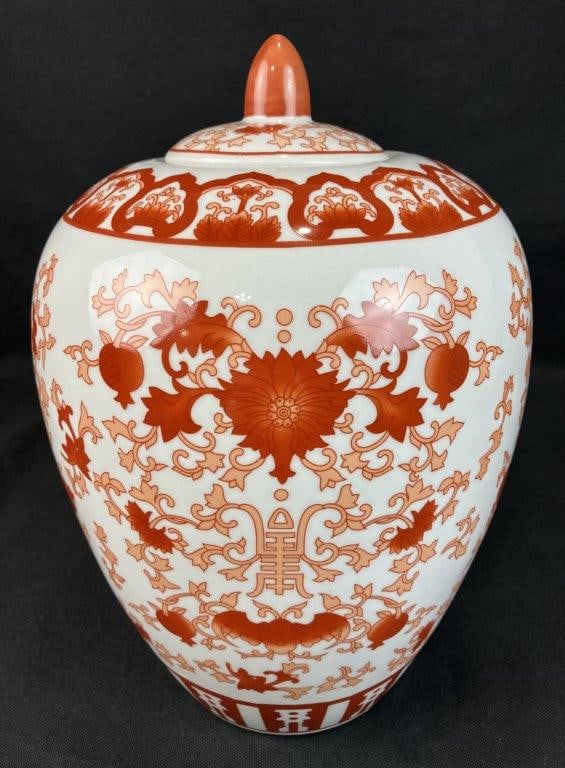 Chinese Red and White Ginger Jar: Elegant porcelain jar decorated with red coral floral designs on a white ground in a traditional form. Measures approximately 13â€³ H x 7â€³ diameter. Good condition. 