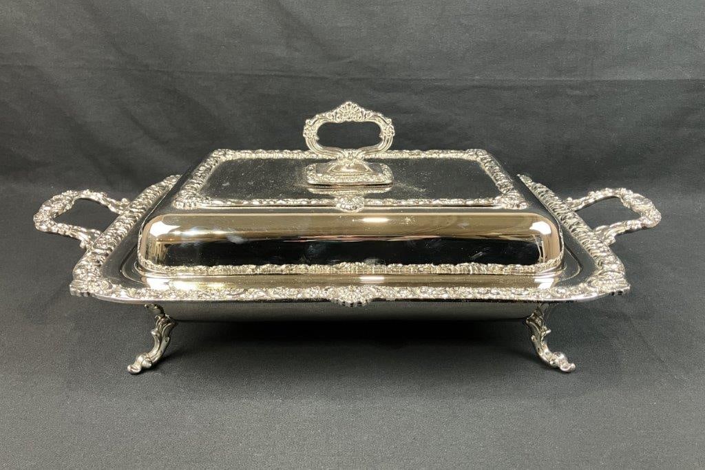 Silverplate Covered Server: Silverplate covered serving dish displaying ornate decoration in a late 19th century design. The piece features shell and scrollwork ornamentation with floral accents throughout, creating an elegant