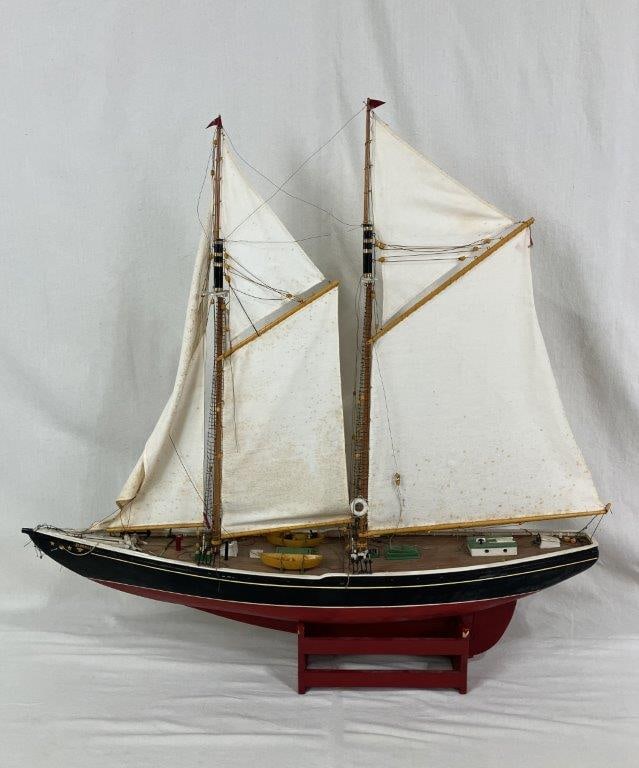 Handcrafted Model Canadian Yacht Bluenose: 20th Century, a detailed scale model of the iconic Nova Scotia double-masted schooner originally launched in 1921. The model captures the form of the famed racing and fishing vessel with intricate