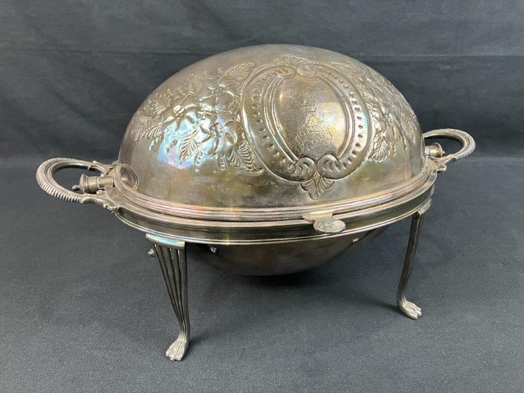 Silverplate Turtleback Covered Server: Silverplate turtleback form covered server featuring repoussÃ© style decoration on the domed lid with floral motifs. The piece rests on a raised base supported by fluted legs terminating in