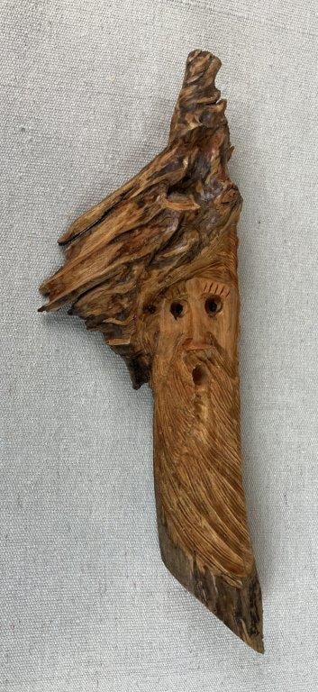 American Folk Art Carved Tree Spirit: American folk art carving executed from a natural tree fragment, depicting a stylized face emerging from the wood grain in the tradition of â€œknot headâ€ or tree