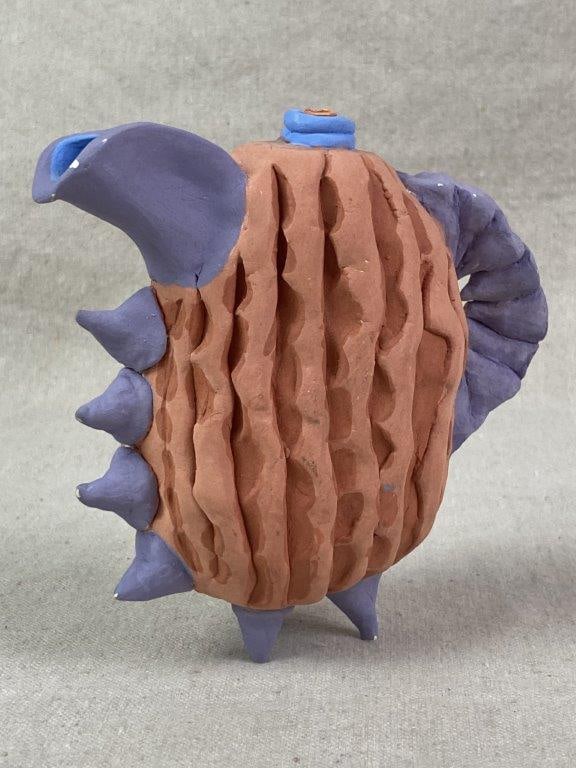 Abstract Teapot by Theo Sable: A non-functional sculptural teapot with a distinct zoomorphic character, featuring a heavily textured ovoid body deeply carved with organic vertical grooves and accented by spike details. The work is