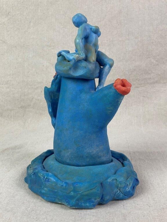 Abstract Teapot Sculpture by Theo Sable: A non-functional two-piece narrative sculpture in the form of a teapot with a fitted base, featuring a stylized reclining female nude figure seated atop the teapotâ€™s lid. The work