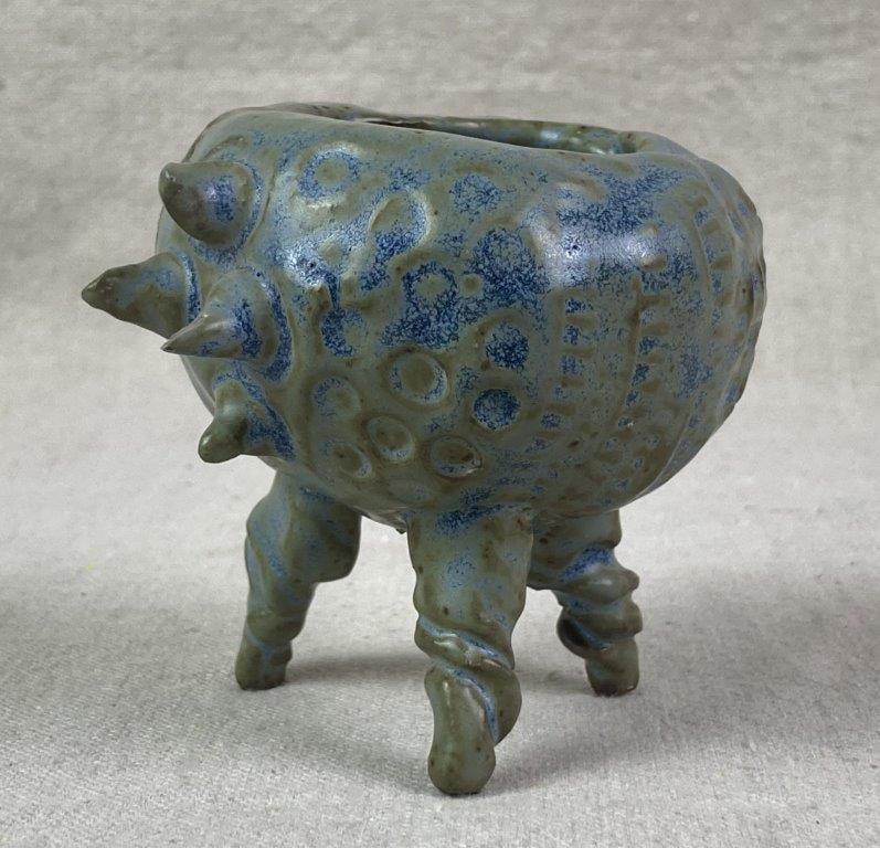 Abstract Pottery Vessel by Theo Sable: A hand-formed, creature-like pottery vessel by Theo Sable featuring a globular body supported on three stout, expressive legs. The surface is decorated with a dynamic combination of applied spikes