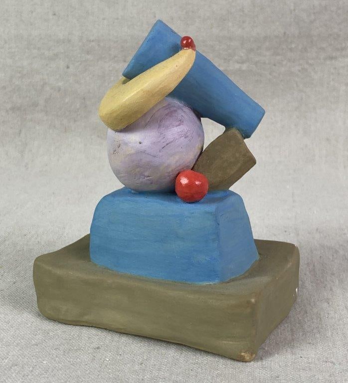 Abstract Still Life Sculpture by Theo Sable: A playful abstract modernist sculpture featuring a stacked, cubist-inspired arrangement of geometric forms in contrasting colors, with a yellow curled element resting on the base, executed in painted