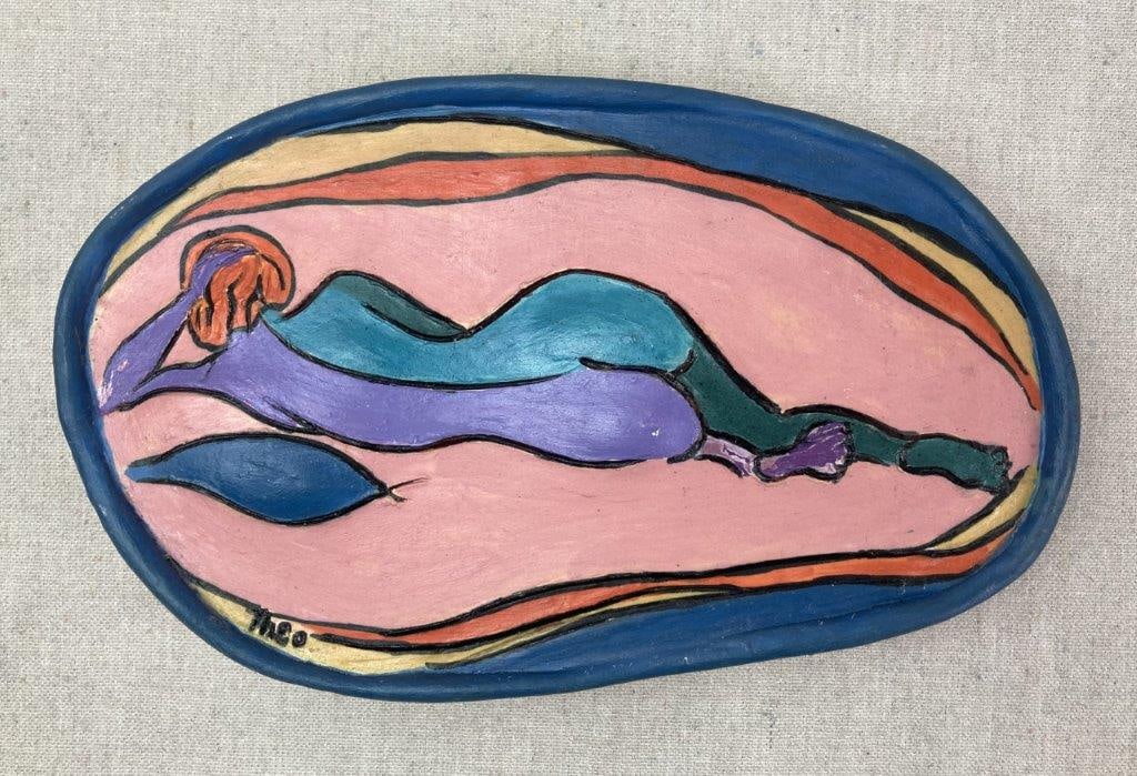 Modernist Painted Plaque by Theo Sable: A hand-formed and painted ceramic oval wall plaque depicting a highly stylized nude female figure reclining on her side, outlined in strong black lines and rendered in a vibrant, non-naturalistic