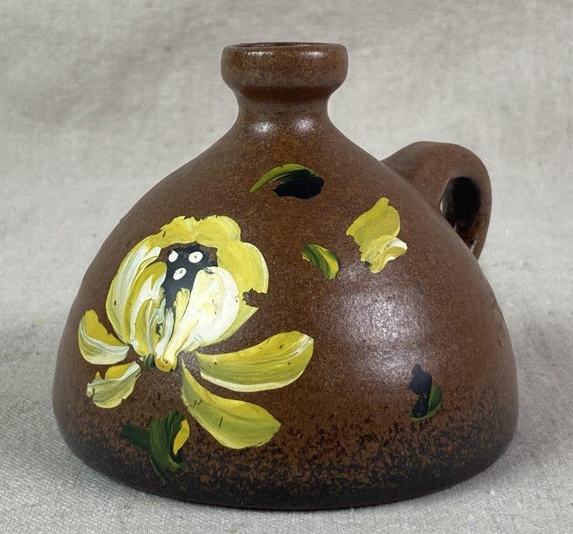 Miniature Painted Pottery Jug: A decorative stoneware jug of squat-bodied form with a short neck and small applied handle, finished in an earthy reddish-brown satin glaze and adorned with a single hand-painted yellow flower. Measur