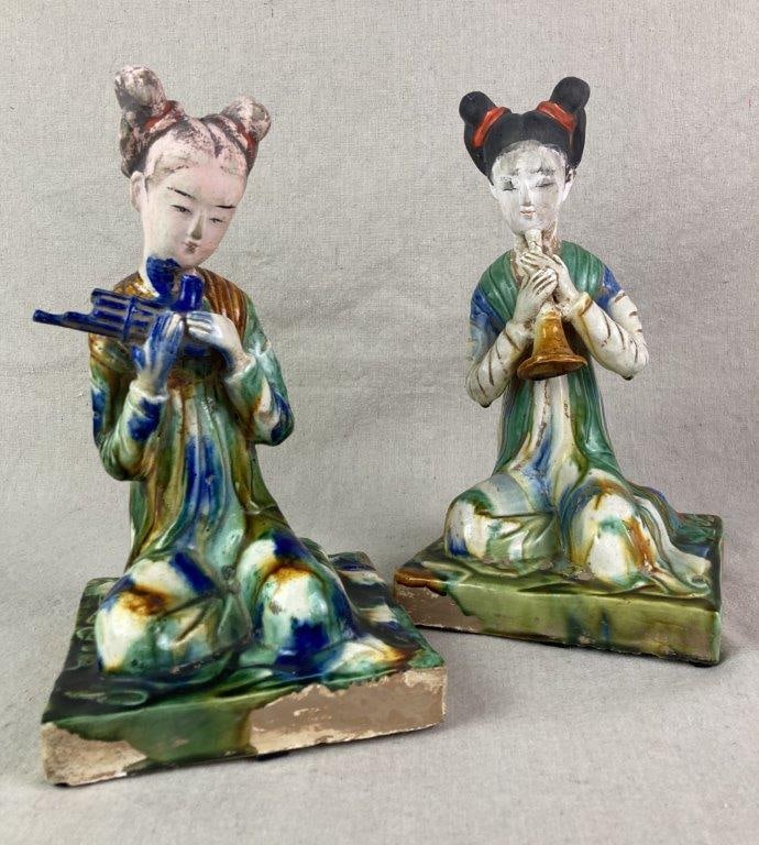Chinese Tang Pottery Musician Statues: two pottery statues, seated women playing wind instruments, vibrant colored glaze in green, blue, and ochre, worn aged patina, The largest statue measures approximately 11 1/4'' H x 6 1/2'' W x 6