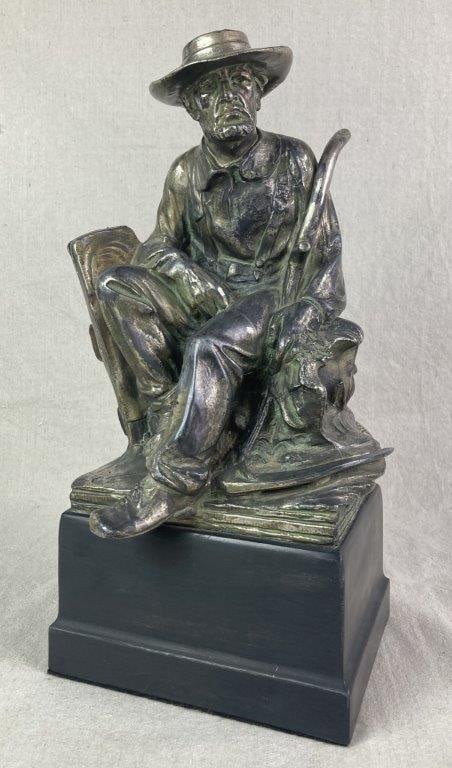 Sculpture of Resting Farmer: Spelter sculpture depicting a resting farmer wearing a wide-brimmed hat with a scythe at his side, featuring finely detailed clothing and facial features, mounted on a rectangular black base.