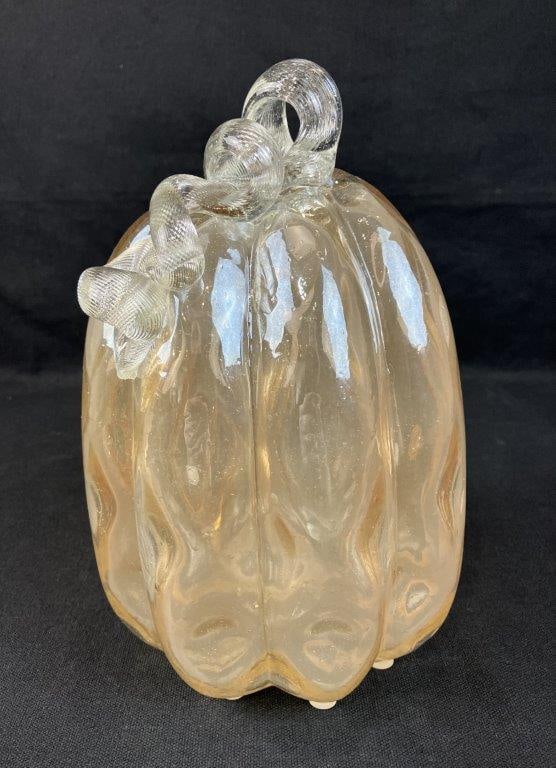 Handblown Glass Pumpkin: Charming pumpkin form in light orange toned glass, created through handblown glass artistry. Measures approximately 10â€³ H x 5â€³ diameter. Good condition. 