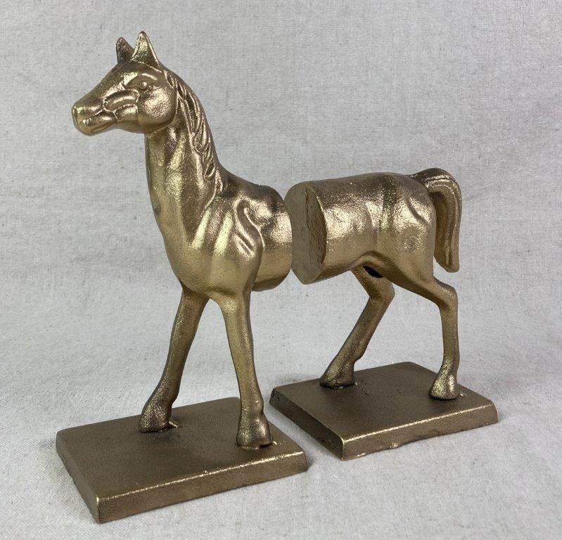 Cast Iron Horse Bookends: Cast iron bookends designed to form a single horse when placed together, featuring a gold-tone finish and detailed body modeling. The tallest section measures approximately 8 1/2â€³ H