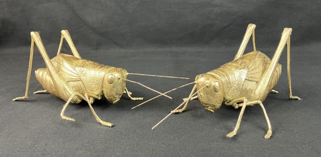 Pair of Gilt Finish Grasshopper Sculptures: Cast resin sculptures with a gilt finish, forming a charming decorative pair. One measures approximately 4 5/8â€³ H x 11â€³ W x 4 1/2â€³ D. Good