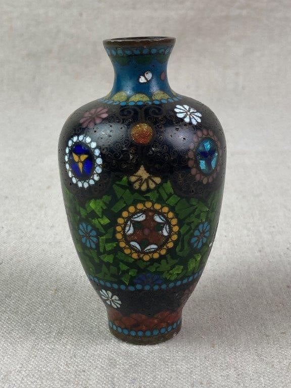Small Japanese Cloisonne Vase: A Japanese cloisonnÃ© vase from the Meiji period decorated with a complex arrangement of floral motifs and medallions set against a dark ground, further accented with green, blue,