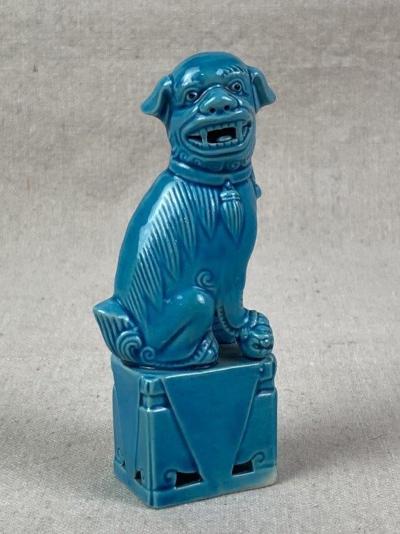 Chinese Porcelain Foo Dog: A turquoise blue porcelain foo dog figure seated on a rectangular pedestal-style base. Measures approximately 4 5/8'' H x 1 1/2'' W x 1 1/8'' D, Good condition. 
