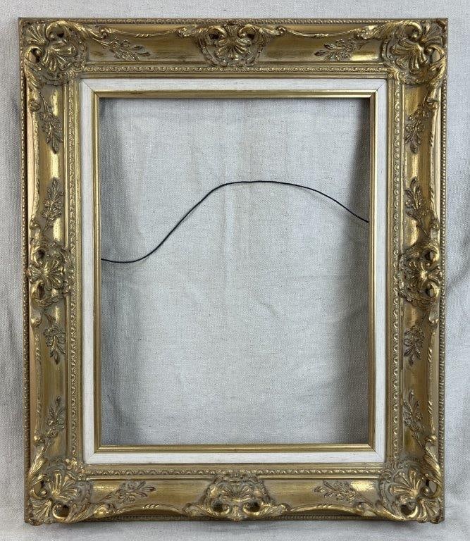 Baroque Style Gilt Frame: Frame in the Baroque taste with ornate decoration and a linen liner with a gilt finish. Inner measures approximately 18" H x 14" W. Measures approximately 25â€³ H x