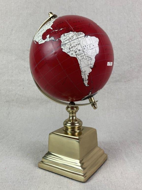 World Globe by Tren Dee: Decorative red globe mounted on a brass base. Measures approximately 10 5/8â€³ H x 5â€³ diameter including the base. Some wear to surface, missing logo and a small