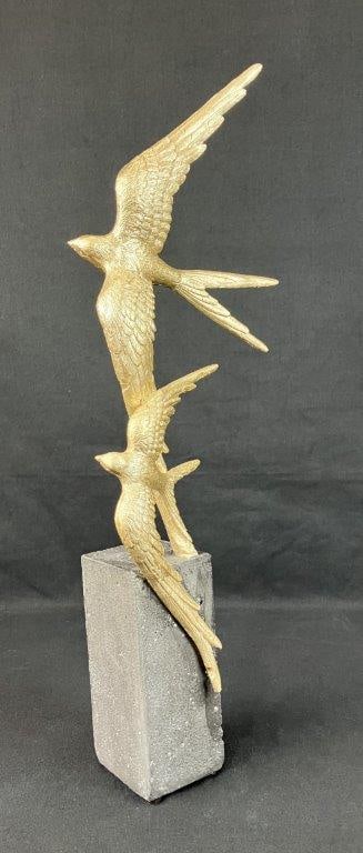Goldtone Bird in Flight Sculpture: Depicts two swallows joined in flight above a dark base. Cast resin construction with goldtone finish. Measures approximately 20â€³ H x 5â€³ W x 3