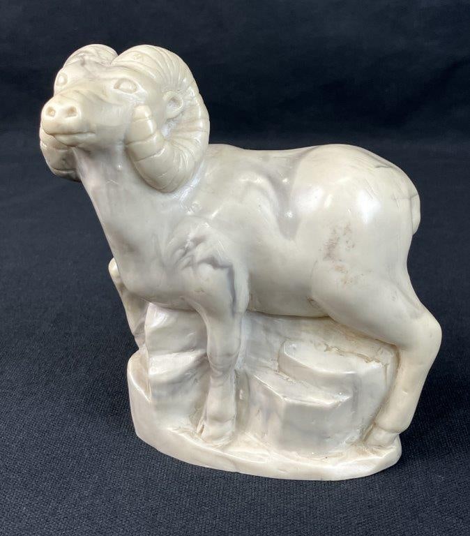 Ram Sculpture: Decorative ram sculpture composed of cast resin with a stone-tone finish, well suited for tabletop decor. Measures approximately 5 3/4â€³ H x 4â€³ W x 2