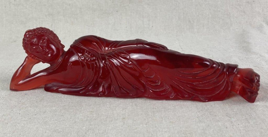 Chinese Reclining Buddha Sculpture: Red leucite sculpture depicting a reclining Buddha with hand-carved details. Measures approximately 3â€³ H x 11 1/4â€³ W x 2â€³ D. Some loss to the