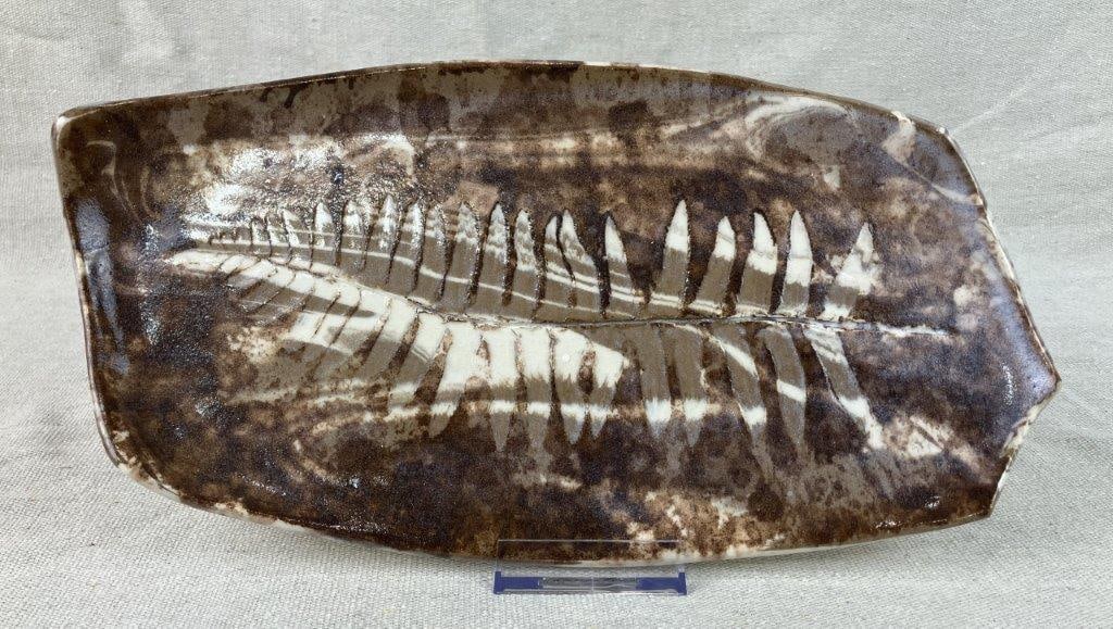 Studio Pottery Fern Motif Tray: Small serving tray featuring a central fern design surrounded by swirling organic forms. Decorated with brown glazing, the design possibly achieved through a resist glazing technique. Measures