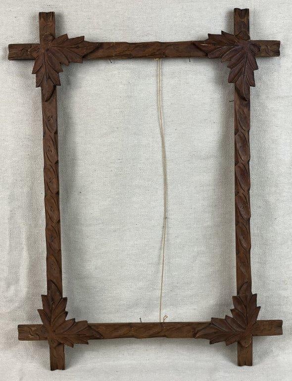 Criss Cross Frame: Antique carved wood frame featuring crisscross construction with carefully crafted detailing and leaf or vegetal motifs at the corners. Executed in mahogany with a rich, warm patina developed over