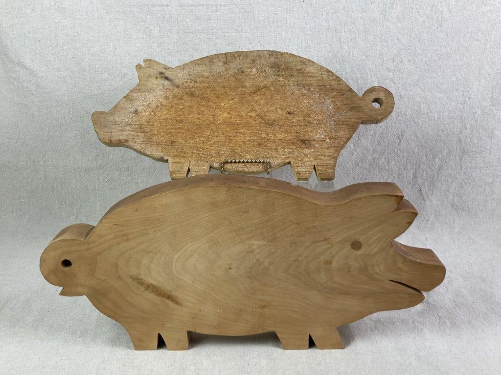 Wood Pig Cutting Boards: Two vintage wood cutting boards in the shape of a pig, one featuring a peg-inserted eye. The largest measures approximately 8 1/2â€³ H x 18 3/4â€³ W x 1