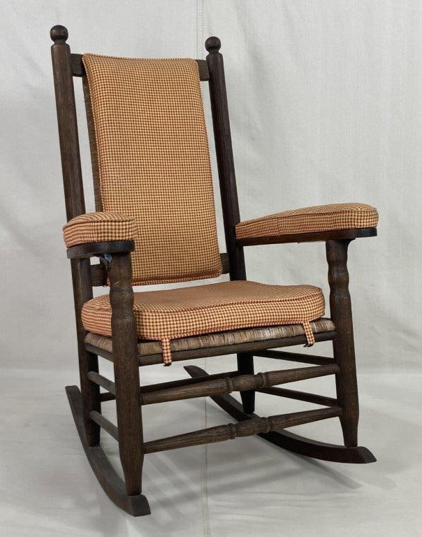 Larry Arata "Kennedy" Rocker: A substantial rocking chair crafted in the tradition of the iconic seat favored by President John F. Kennedy. This piece is constructed of oak with a rich, warm patina and features classic turned