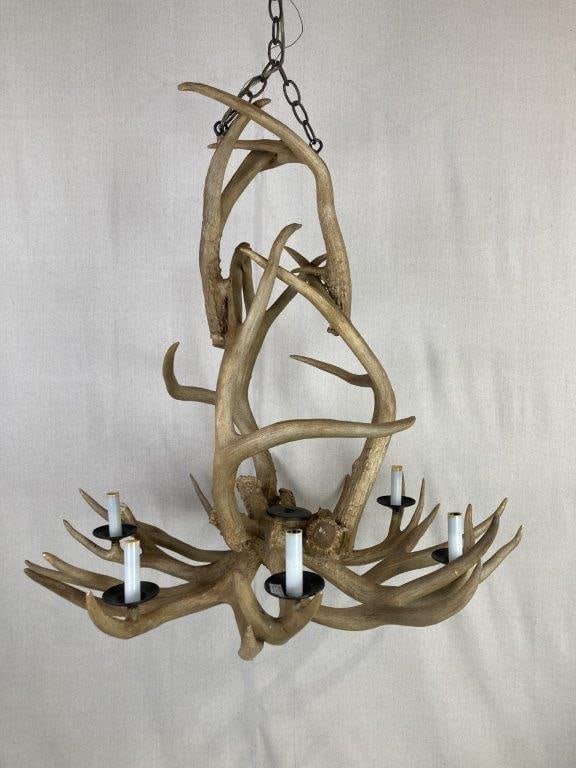 Antler Chandelier: This handsome lighting fixture is expertly crafted from genuine stag antlers, arranged to create a rustic and organic silhouette. The chandelier features six candle-style light sockets mounted