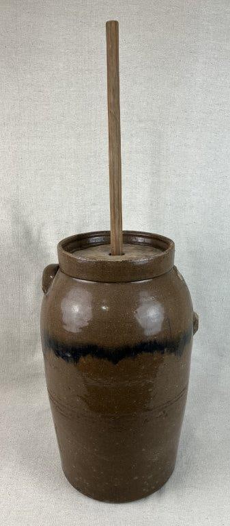 Joe Johnson Stoneware Churn, Laurens County: Southern stoneware churn attributed to Joe Johnson of Laurens County, featuring a glaze typical of his work. The vessel retains its cover and original churn dash, along with one lug handle; an