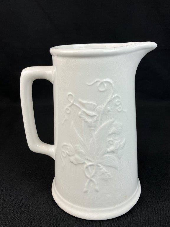 Wm. Adams & Sons Ironstone Pitcher: English ironstone pitcher by Wm. Adams & Sons featuring an embossed raised relief floral pattern on a classic form. The piece displays traditional craftsmanship with decorative surface detail typical