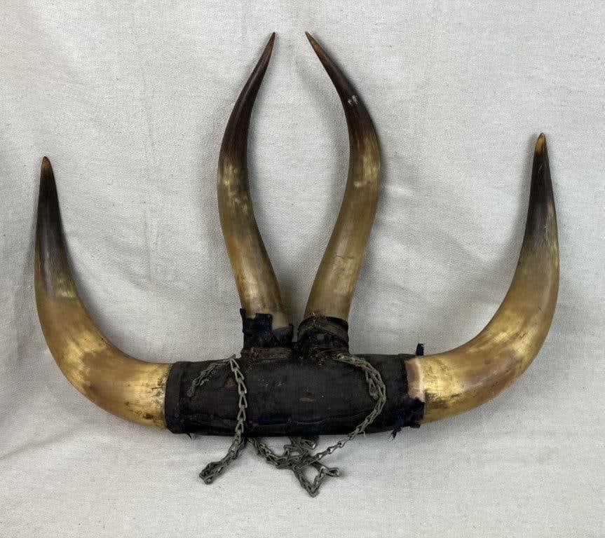 Folk Art Horn Wall Art: Folk art wall piece crafted from large steer horns, arranged to create a bold decorative accent suitable for wall display. The natural curvature and scale of the horns give the piece a strong visual