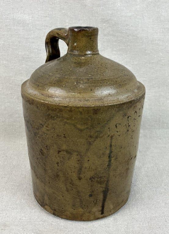 J.D. Brewer Georgia Alkaline Glaze Jug: Barrow County, GA, circa 1900; features a rich green alkaline glaze in a traditional stacker form; measures approximately 9 1/2" H x 6" in diameter; condition includes some abrasions and