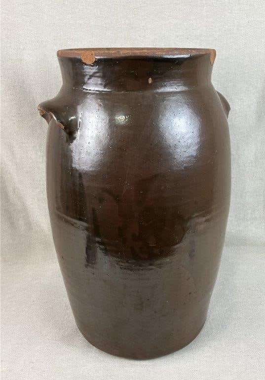 Large Six-Gallon Albany Slip Stoneware Churn: This impressive utilitarian churn features a slightly curving form with two applied lug handles and is finished in a traditional, rich Albany slip glaze. Designed for a significant six-gallon