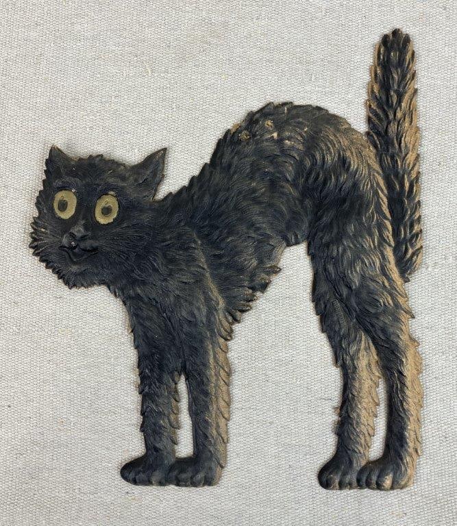 Vintage Halloween Black Cat Die-Cut Decoration: Vintage Halloween ephemera in the form of a black cat, executed in heavily embossed and painted cardstock with die-cut construction. The piece reflects classic Halloween imagery and retains strong