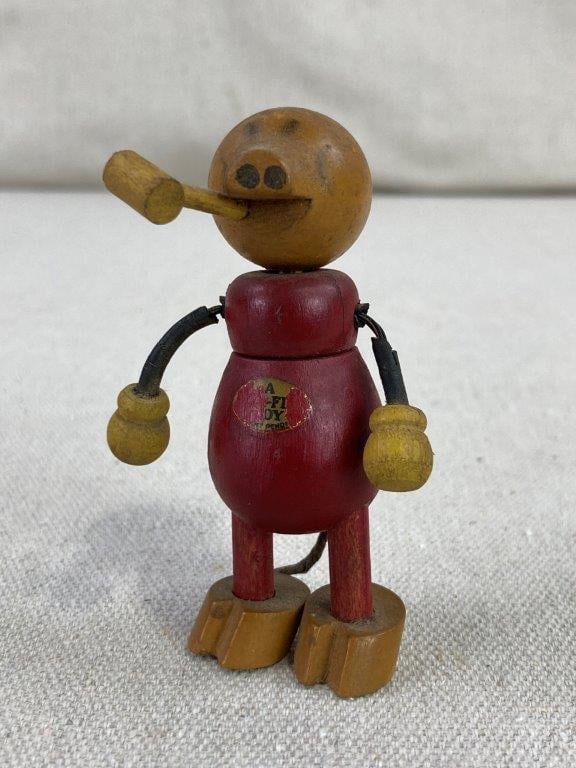 Fun-E-Flex Wood Pig Toy: This rare collectible toy features the signature articulated design of the Fun-E-Flex line, known for its whimsical wooden figures. The pig is crafted with a vibrant red painted body and a