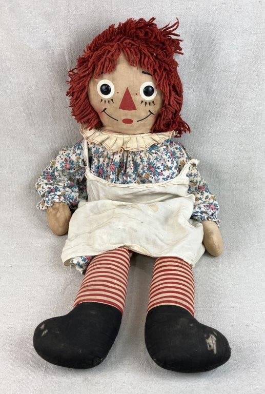 Large Raggedy Ann Doll: Classic Raggedy Ann doll most likely by Knickerbocker Toy Company featuring button eyes, red yarn hair, a floral dress, and red and white striped stockings. The doll displays the iconic design
